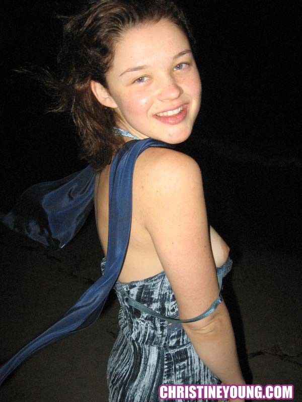 Cheerful teen Christine Young poses after dark on the beach #73118600