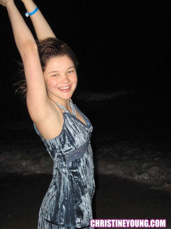 Cheerful teen Christine Young poses after dark on the beach #73118621