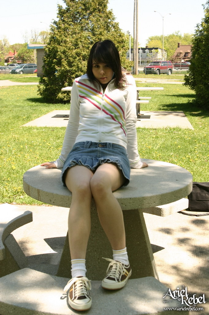 Teen wearing short jean skit in park #67271214