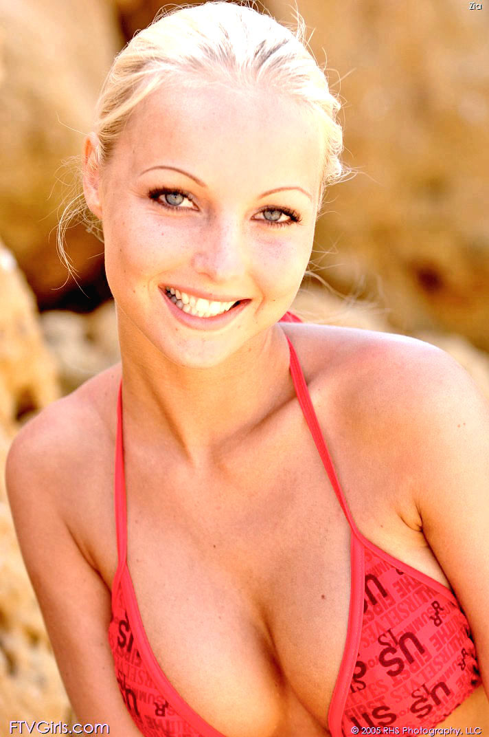 Blonde wearing bikini posing on the beach #73203099