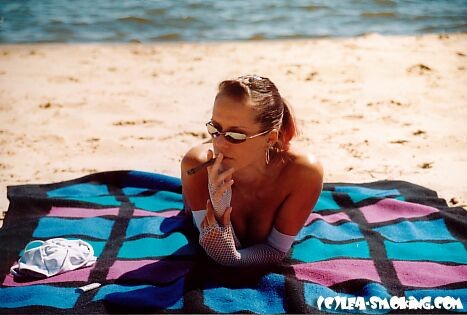 teen smoking at the beach #72322986