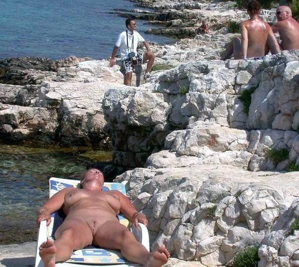 Lying out in the hot sun is this nudist's favorite #72253181