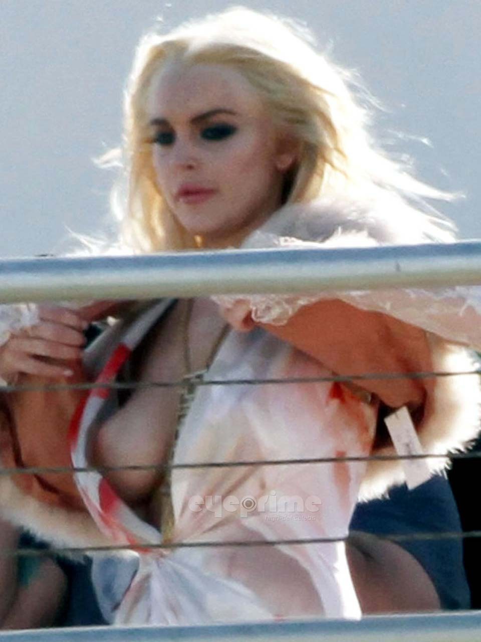 Lindsay Lohan flashing her boobs while doing some photoshoot paparazzi pictures