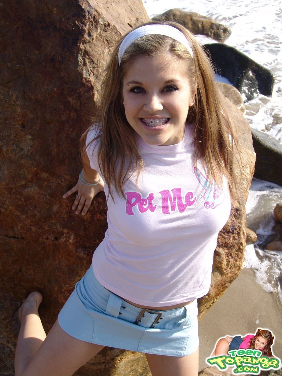 Petite teen shows perky small tits and round ass on the beach