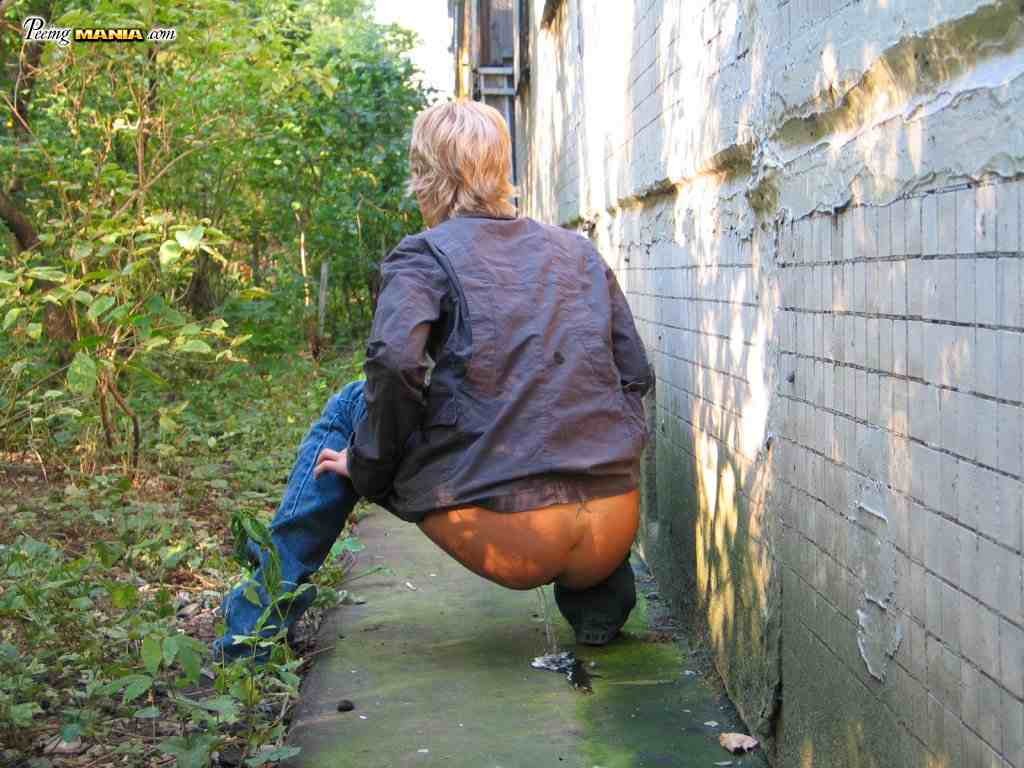 Blonde girl pissing outdoors #76587290