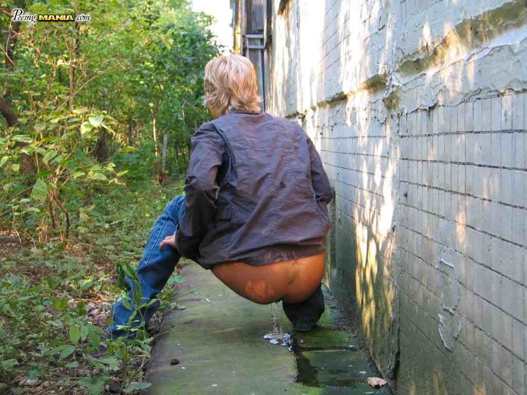 Blonde girl pissing outdoors #76587304