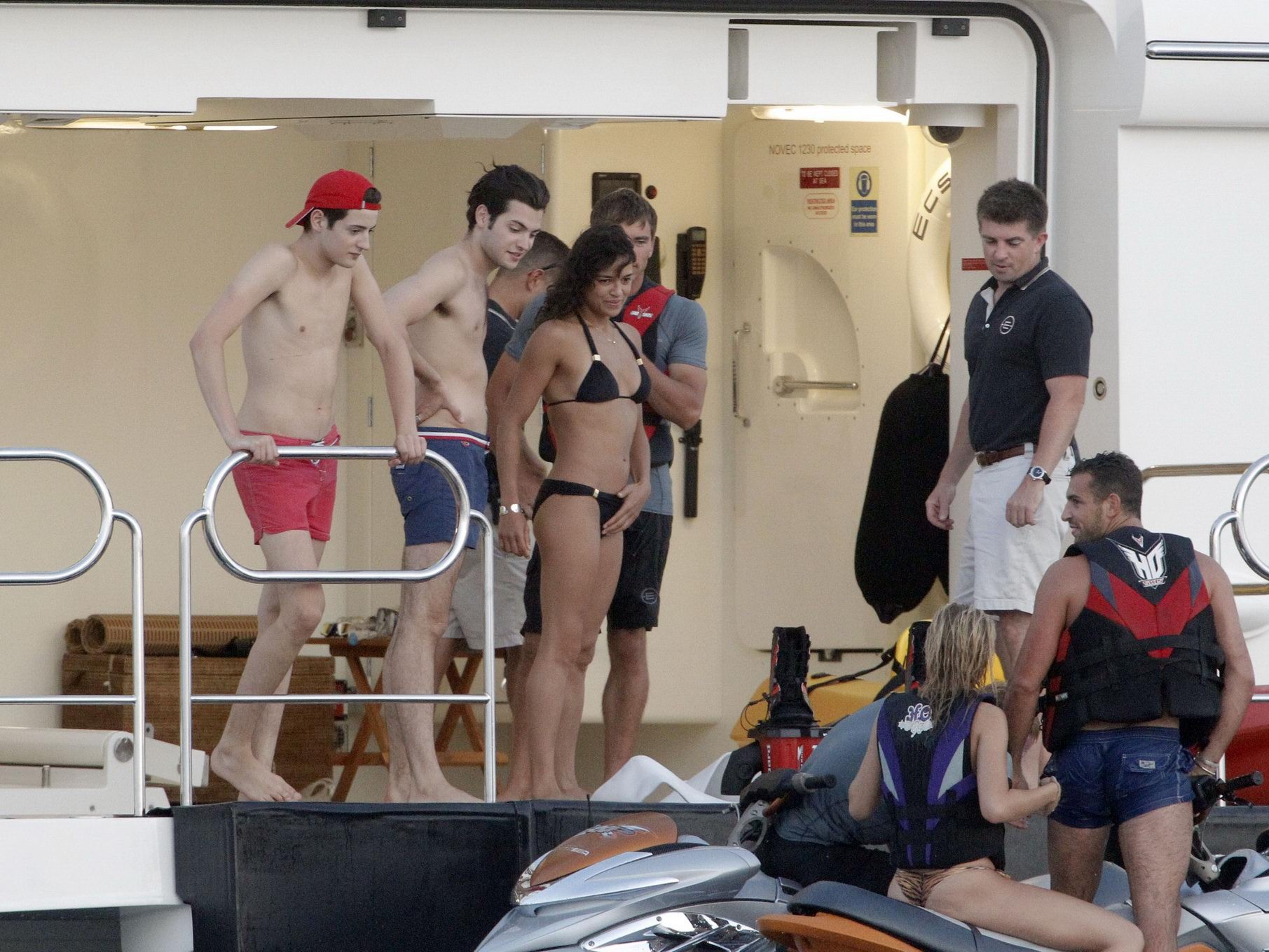 Michelle Rodriguez wearing a sexy black bikini on a yacht in Formentera