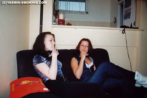 Two teens smoking on the couch #79055228