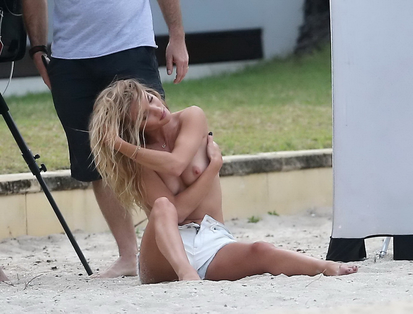 Rosie Huntington-Whiteley topless in a white denim shorts doing a beach photosho