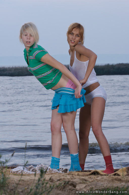 Two exciting blonde teens stripping and teasing on the sea shore #78184102