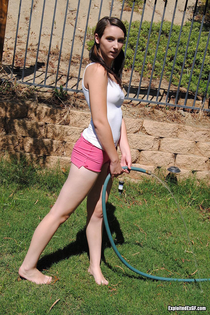 Solo sweet girl playing with the hose outdoor