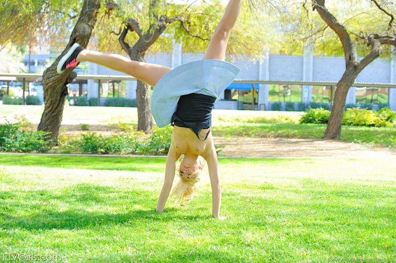Daring blonde girl does naked cartwheels in the park #67291528