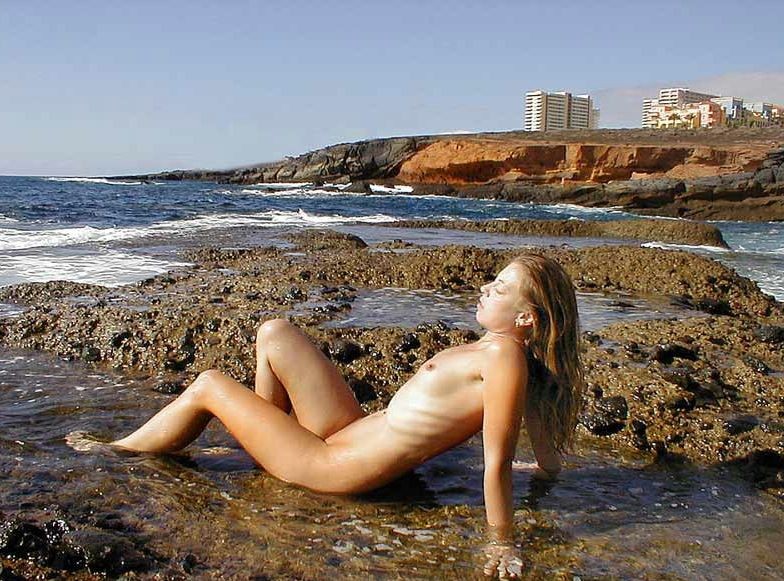 Amateur couple posing nude at a public beach #72251501