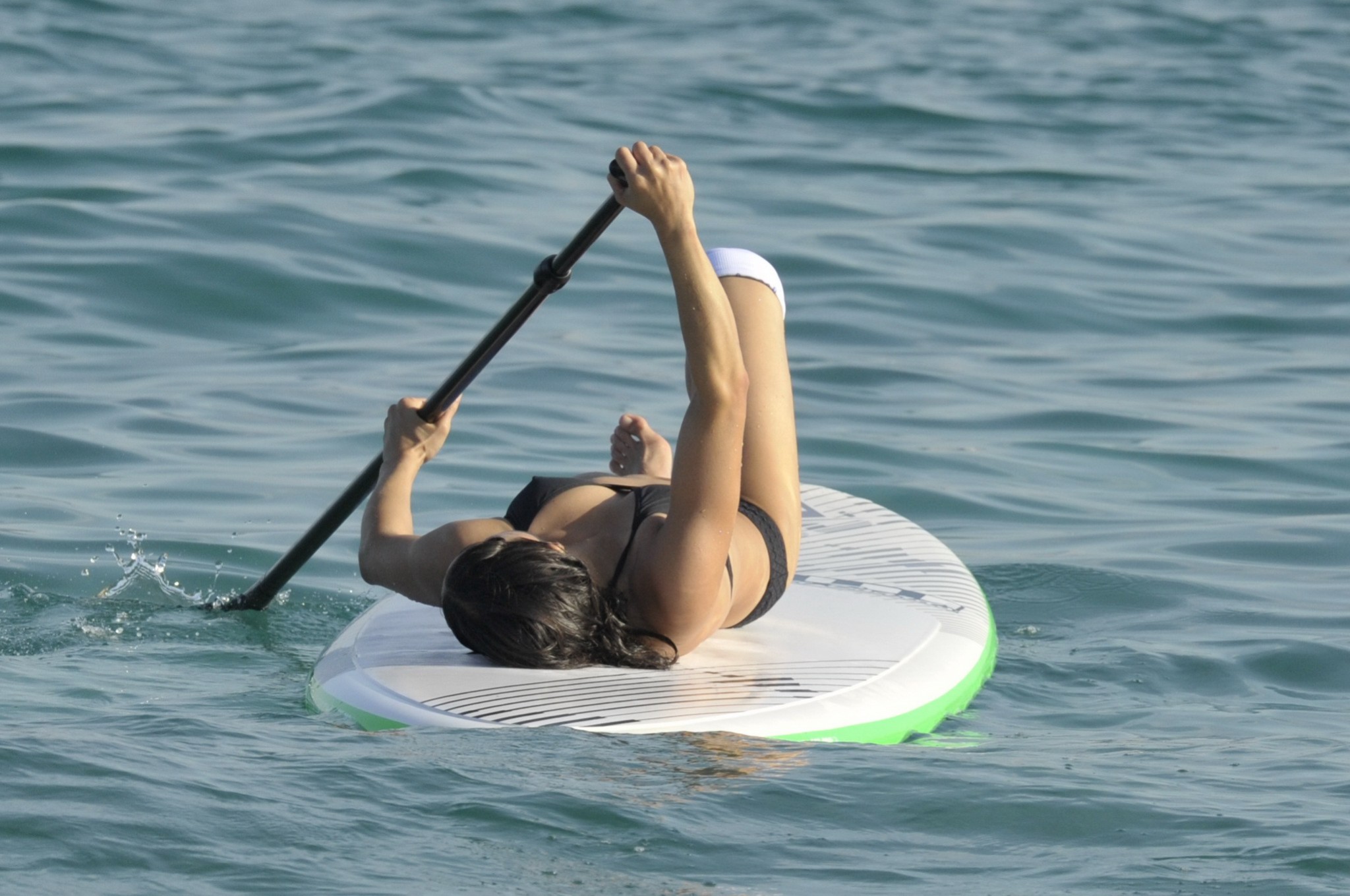 Michelle Rodriguez paddling in skimpy black bikini #75155820