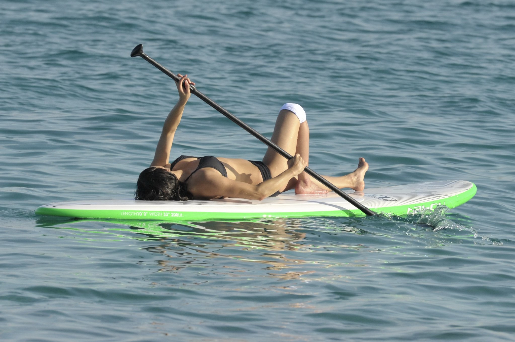Michelle Rodriguez paddling in skimpy black bikini #75155826