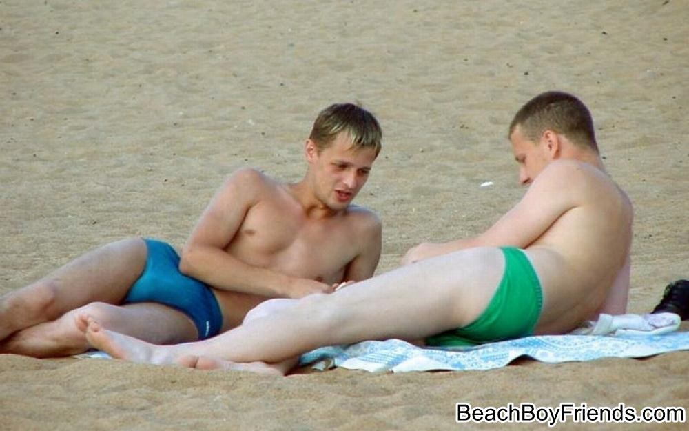 筋骨隆々の男たちがビーチでトップレスになっている
 #76945142