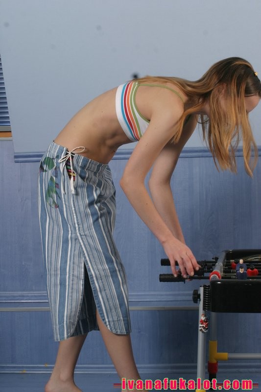 Two pretty teens playing table soccer #70664872