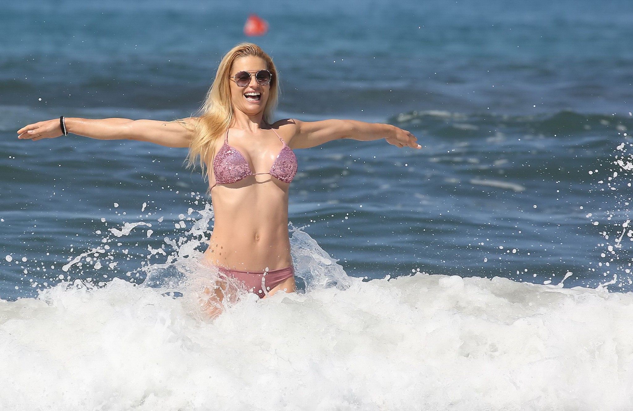 Michelle Hunziker busty in a tiny pink bikini at the beach #75140643