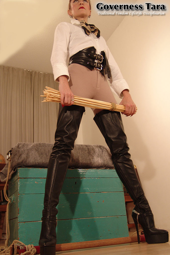Strict domina in jodphurs and leather coat and riding boots #72185429