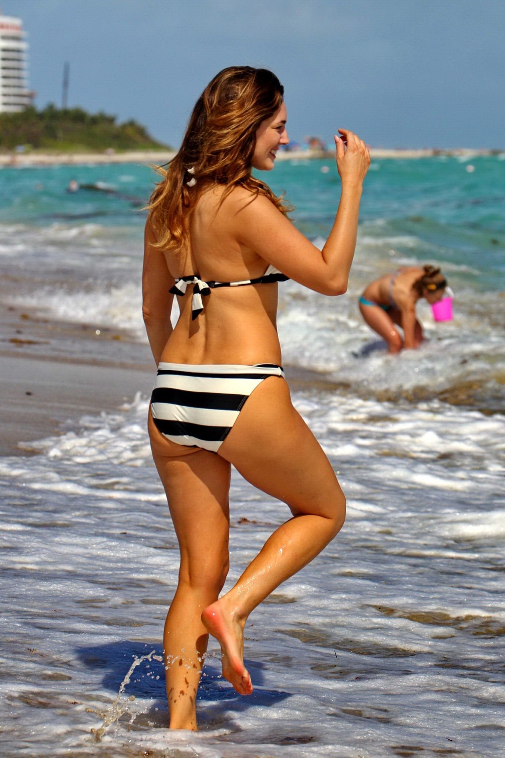 Busty Kelly Brook wearing a striped bikini on a beach in Miami #75205446