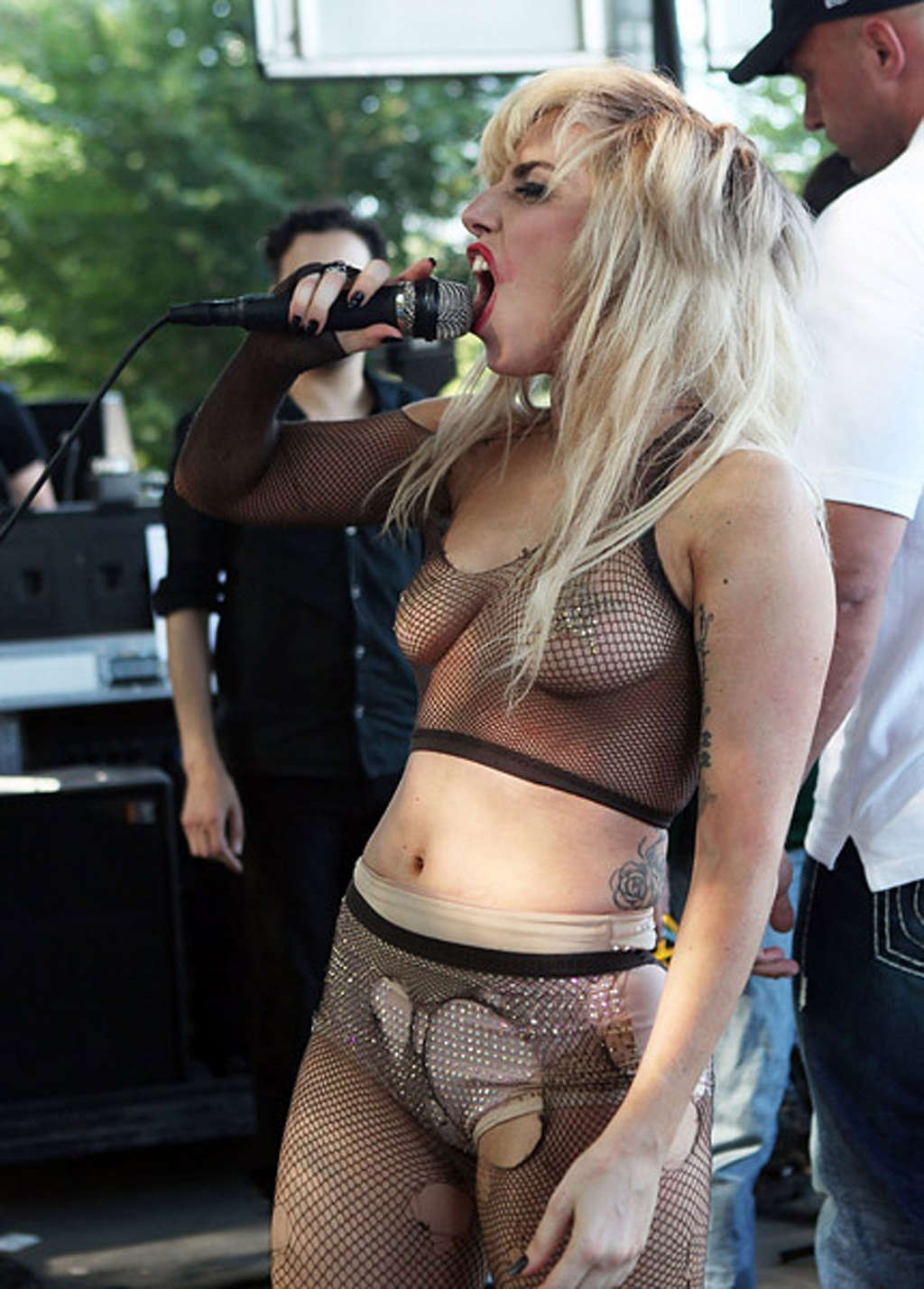 Lady Gaga with tape covering her nipples in see thru top on stage #75337545