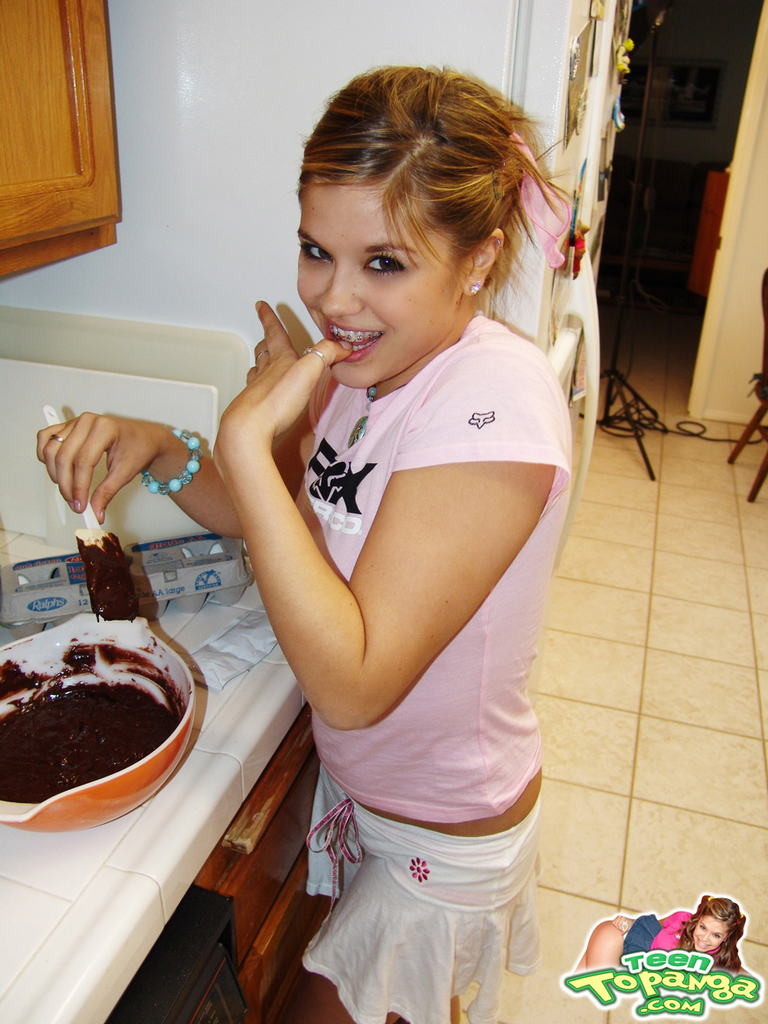 Eighteen year old bakes cake and strips in kitchen #78743220