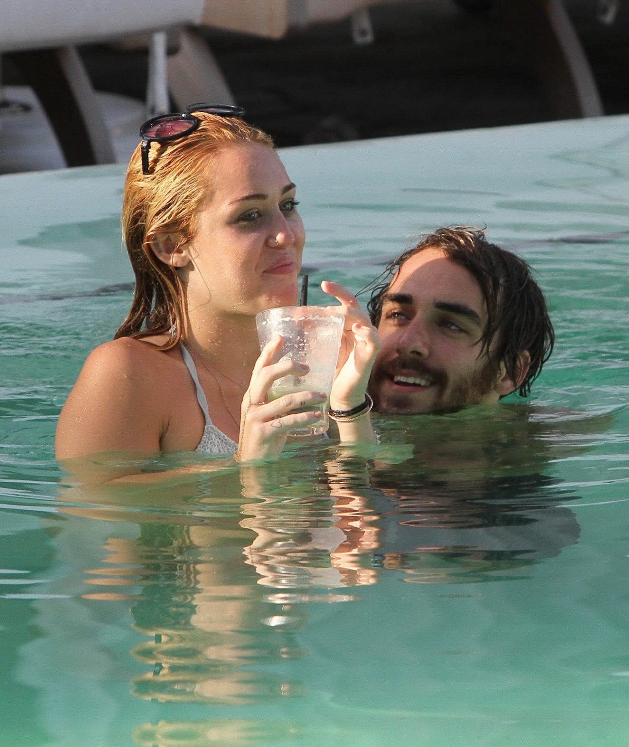 Miley Cyrus wearing white bikini at a hotel pool in Miami #75260239