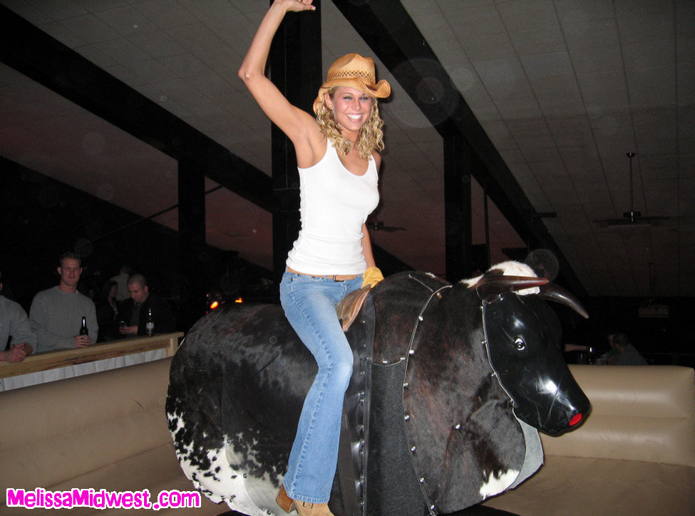 Melissa Midwest riding a mechanical bull #67275099