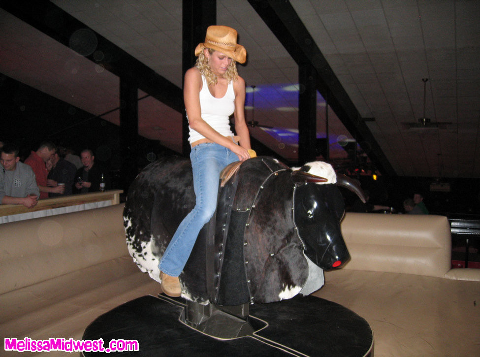 Melissa Midwest riding a mechanical bull #67275121