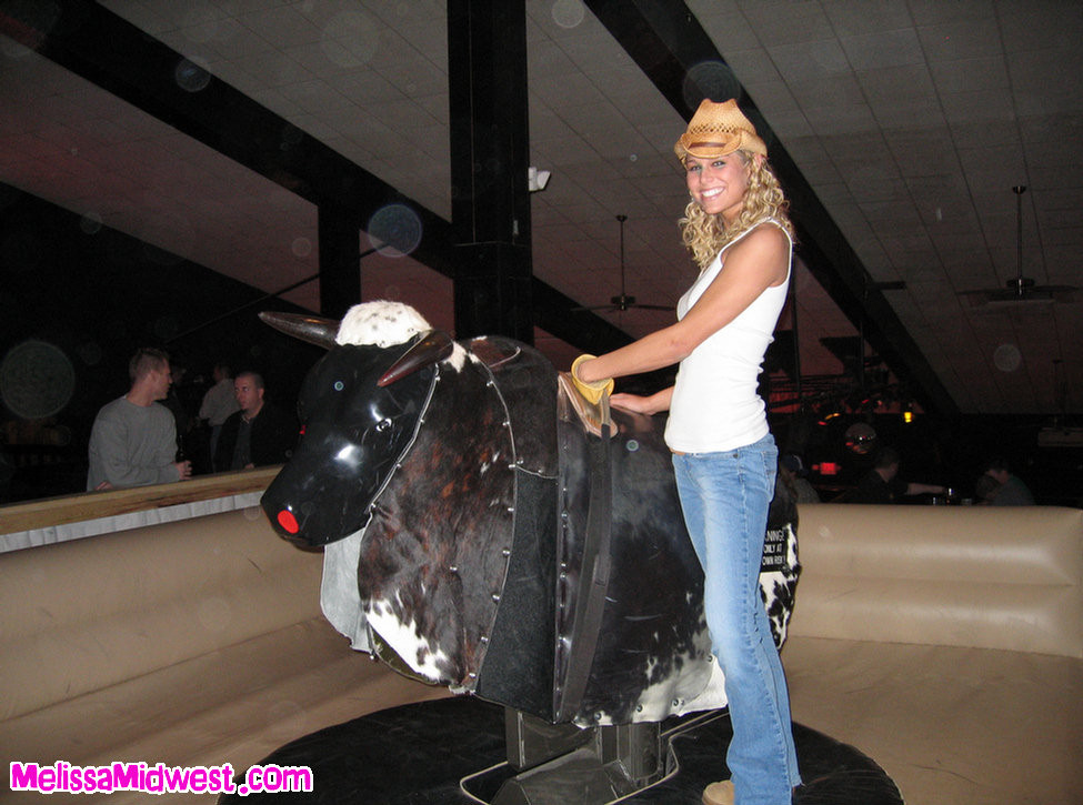 Melissa Midwest riding a mechanical bull #67275132