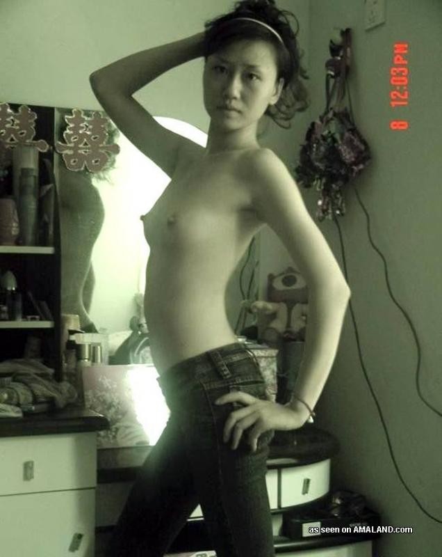 Une jeune femme chinoise posant seins nus pour son amant excité à la maison.
 #69776724