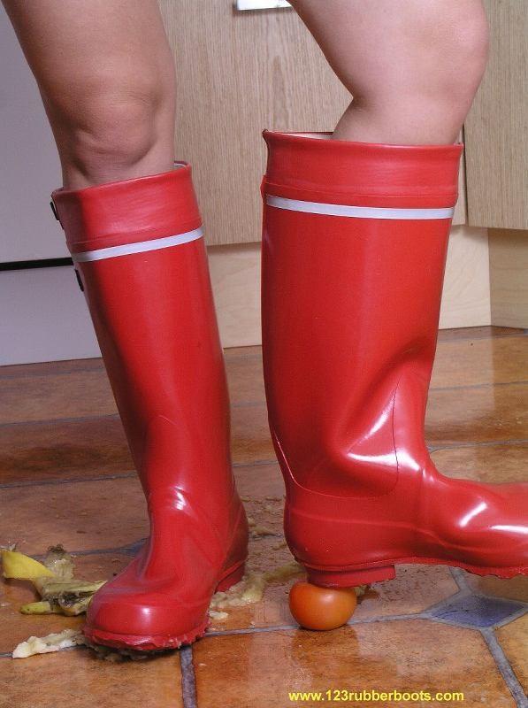Hot girl crushing vegetables with her rubber boots #73287282