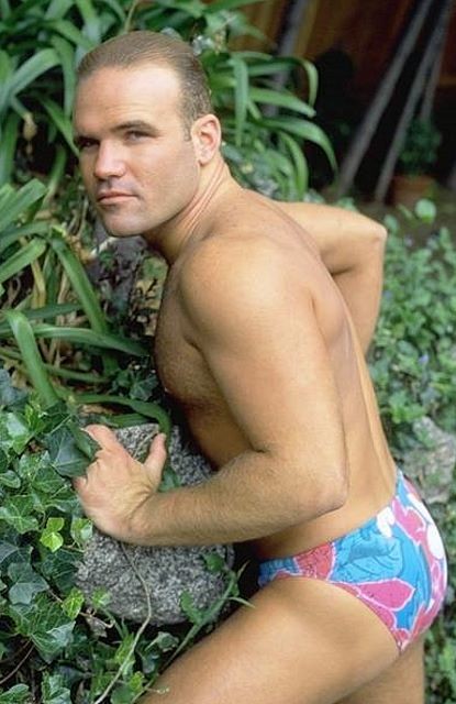 A hairy chested outdoor knight showing in and out of speedos #76973185