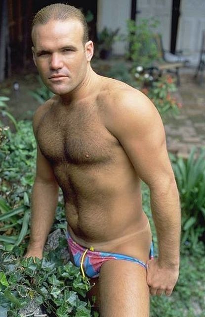 A hairy chested outdoor knight showing in and out of speedos #76973190