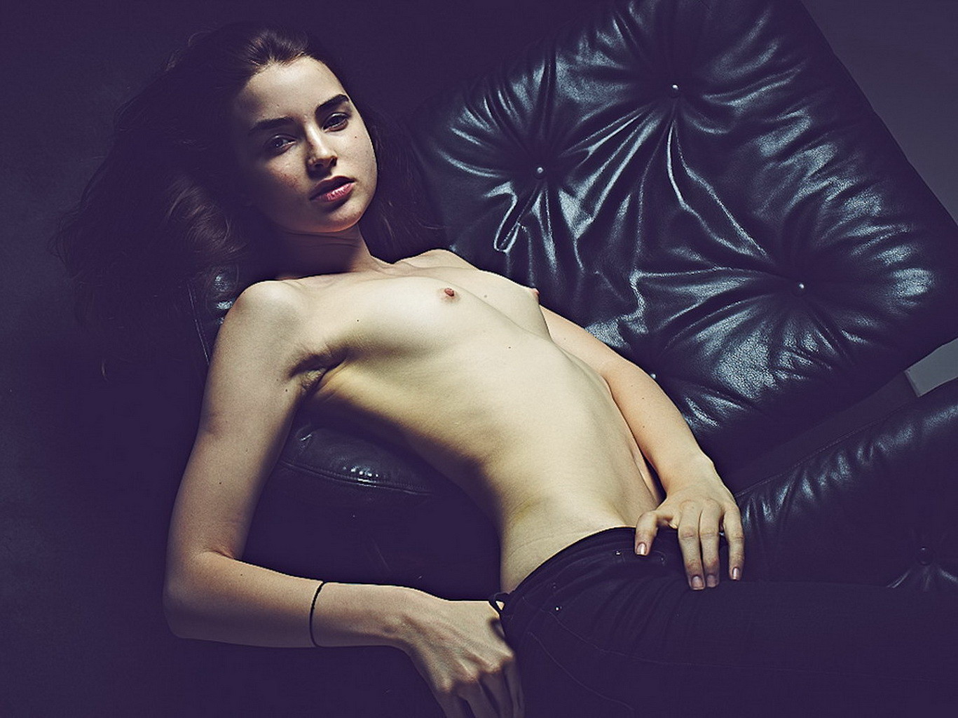 Ali Michael posing topless on a black sofa before nipplepiercing #75185092
