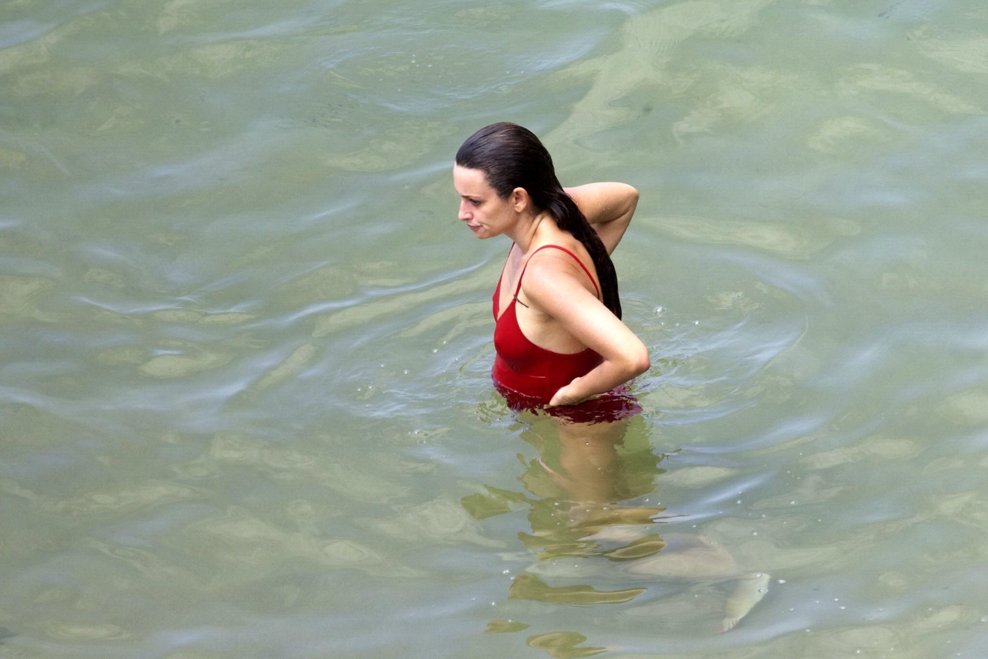 Penelope Cruz showing pokies on a beach wearing a sexy red swimsuit #75192236