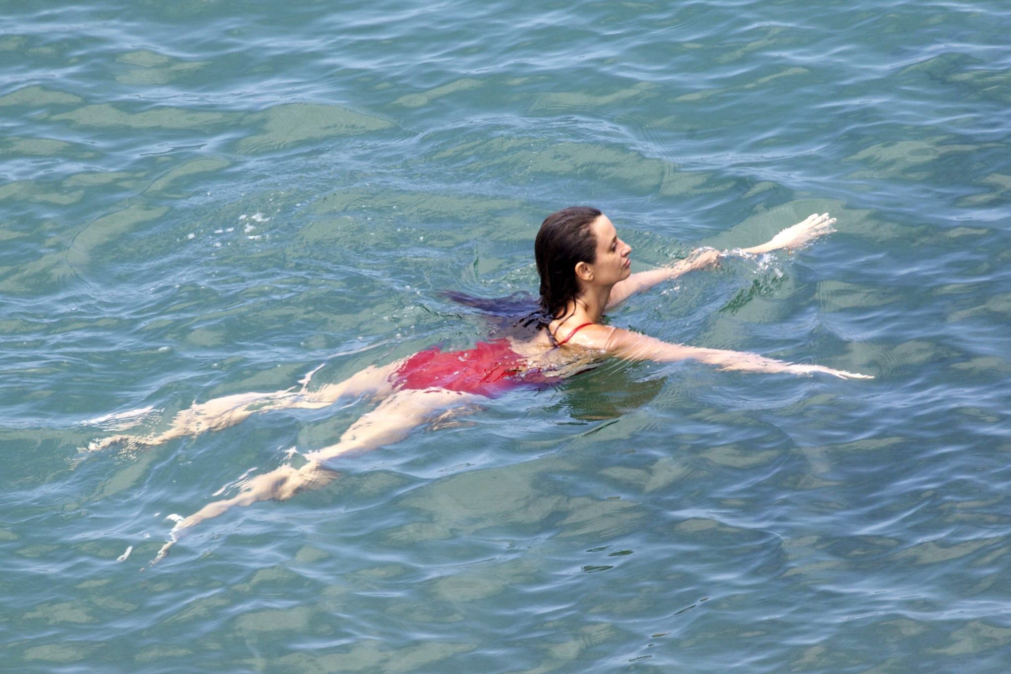 Penelope Cruz showing pokies on a beach wearing a sexy red swimsuit #75192268