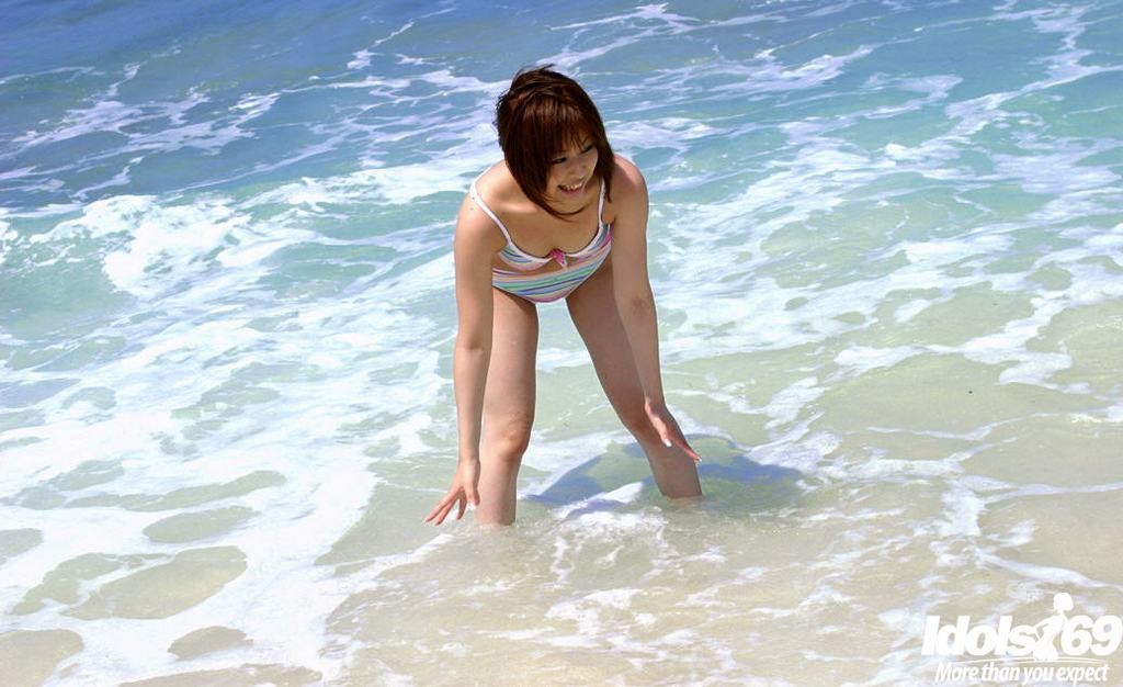 Sweet tiny titted Asian teen strips and teases on a sandy beach #69957444