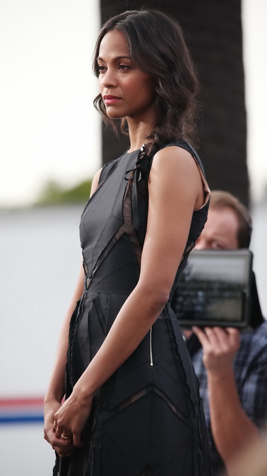 Zoe Saldana wearing black partially see-through mini dress on 'Extra' set at the #75211086