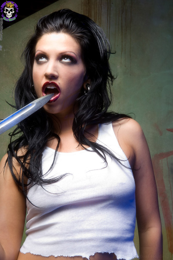 hot brunette gothic girl plays with a knife #70610357