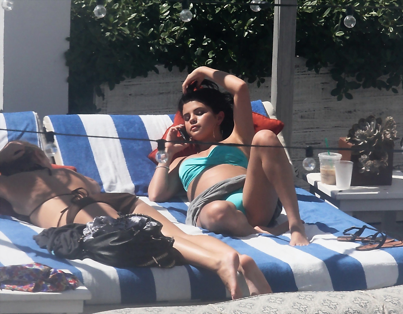 Selena gomez montrant son pied de biche et ses gros seins dans un bikini bleu clair à la piscine. 
 #75252447