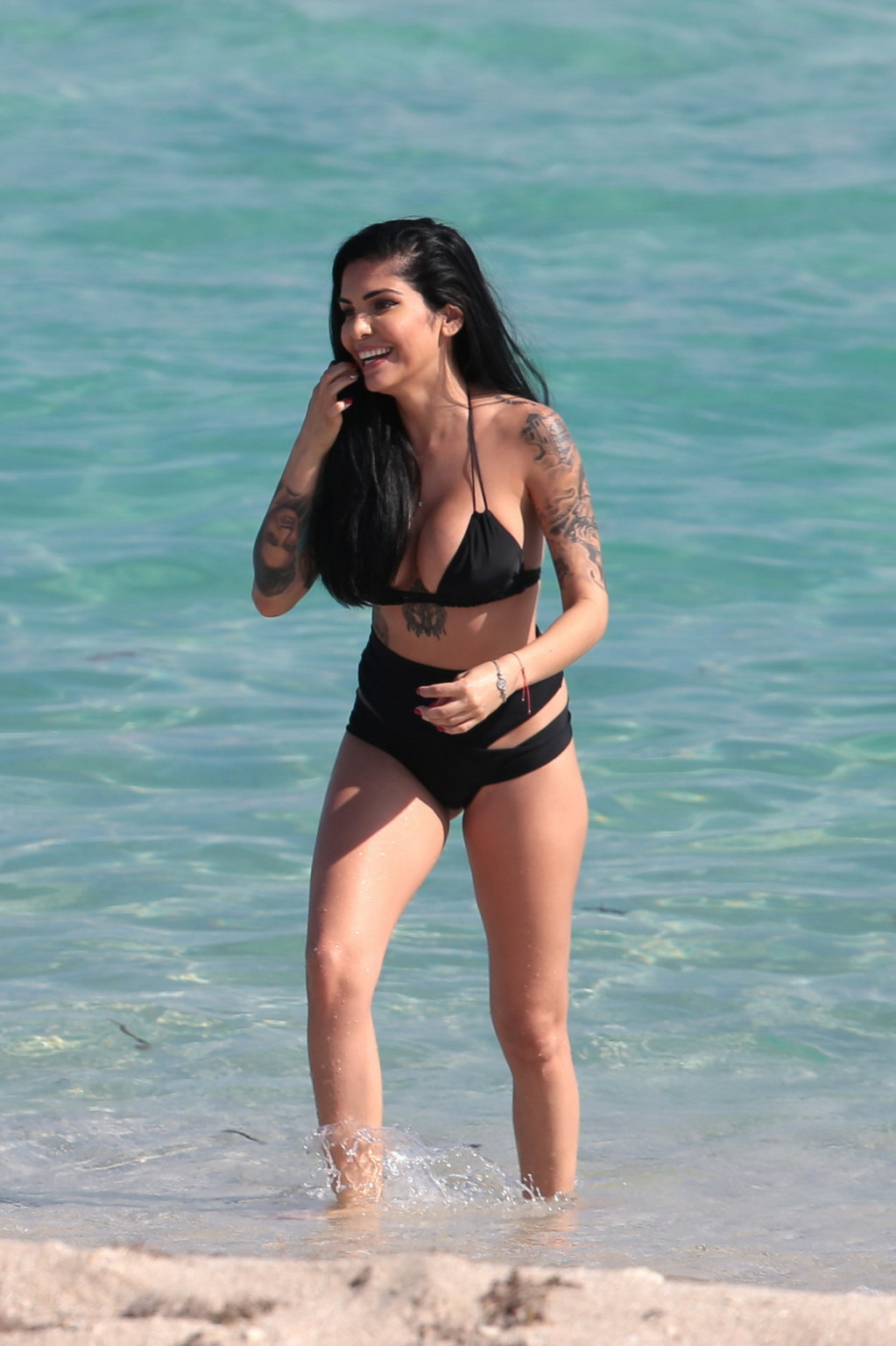 Cami Li showing sideboob and ass in black bikini at the beach in Miami #75175377