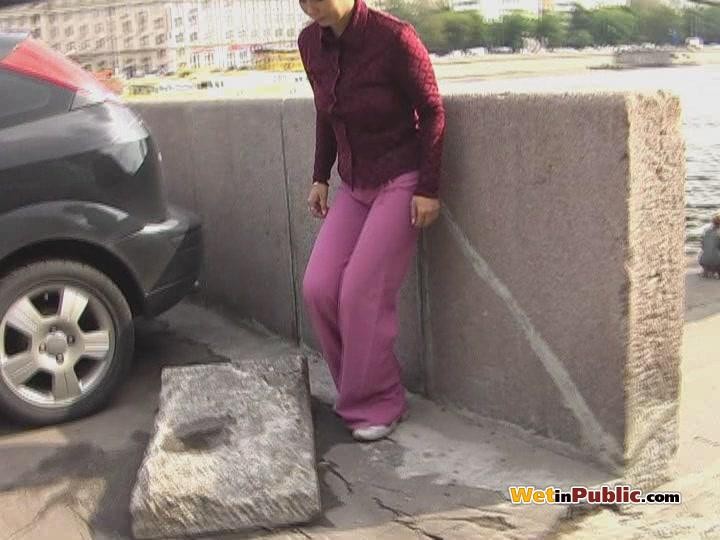 Embarrassed angel peeing in her amazing pants behind a car in public #78595160