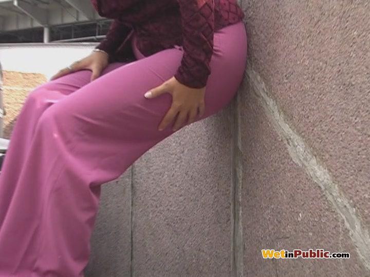 Embarrassed angel peeing in her amazing pants behind a car in public #78595175