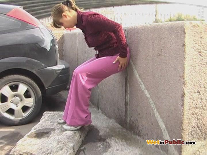 Embarrassed angel peeing in her amazing pants behind a car in public #78595186