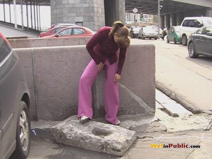 Embarrassed angel peeing in her amazing pants behind a car in public #78595217