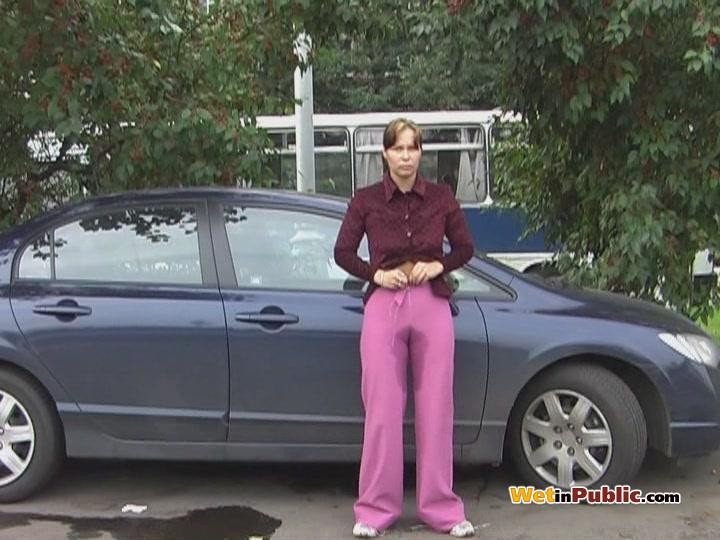 Embarrassed angel peeing in her amazing pants behind a car in public #78595223