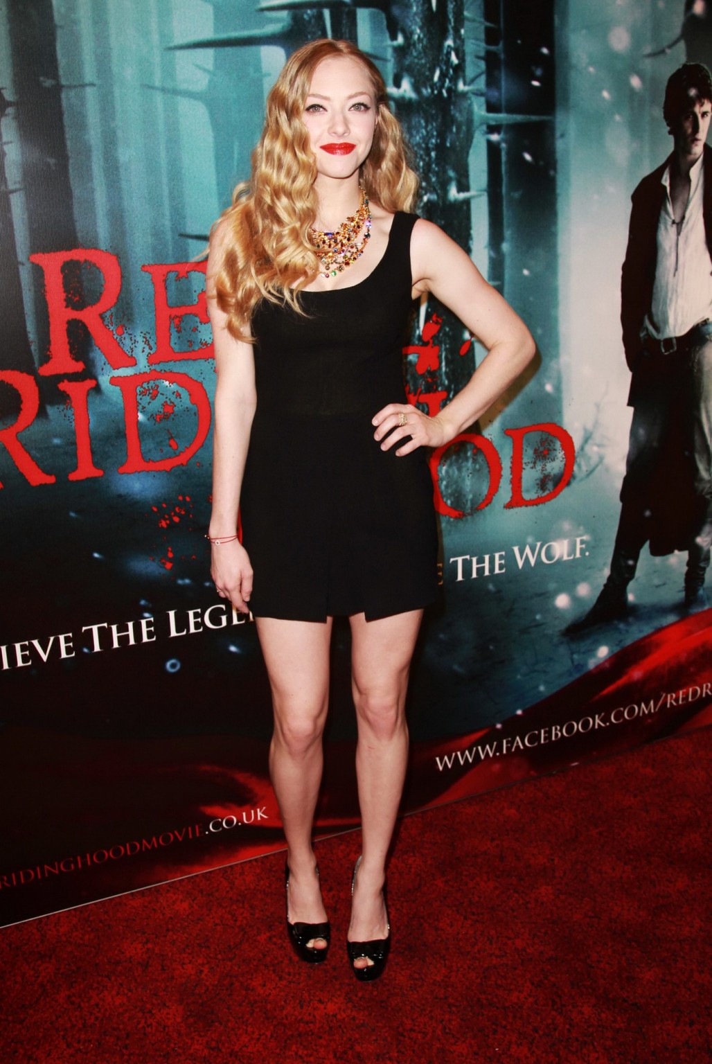 Amanda seyfried portant une petite robe noire à l'écran du "chaperon rouge" avec de belles jambes
 #75309764