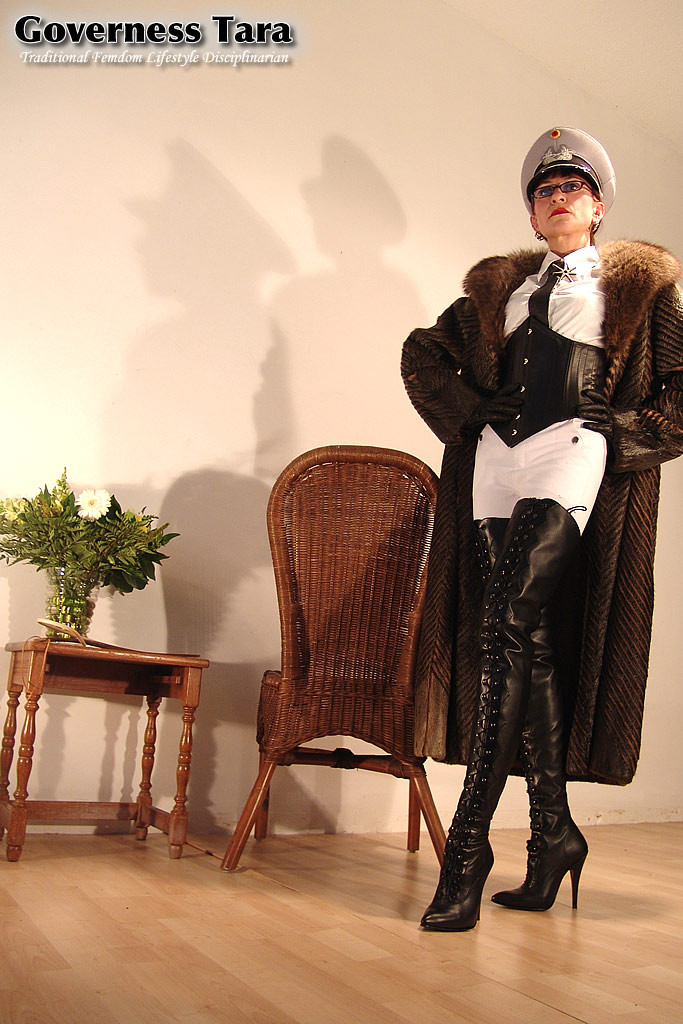 Mature but strict mistress in leather and fur coat posing #72186976