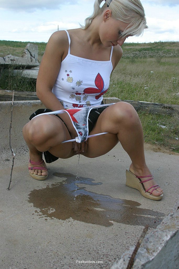 Yummy blonde teenie sits down and takes a piss outdoors #78695171